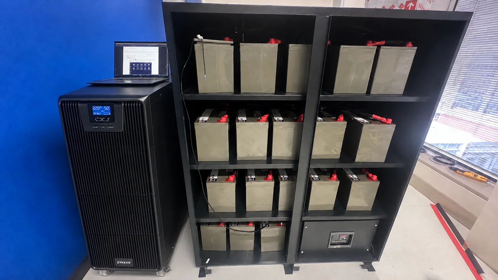 TITAN UPS beside an open external battery cabinet in a field reference image