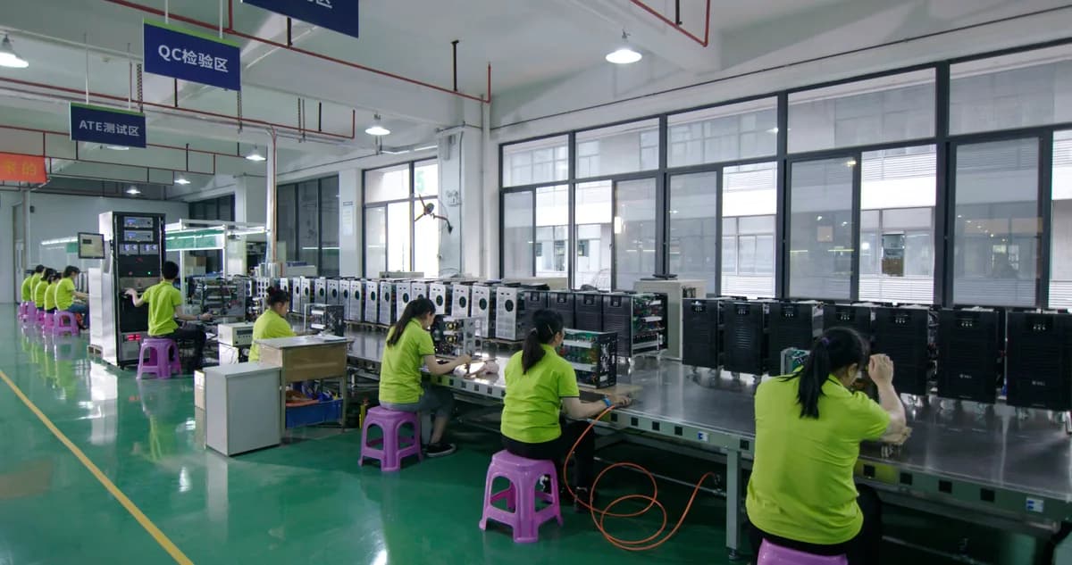 UPS units and technicians in a QC and ATE testing area